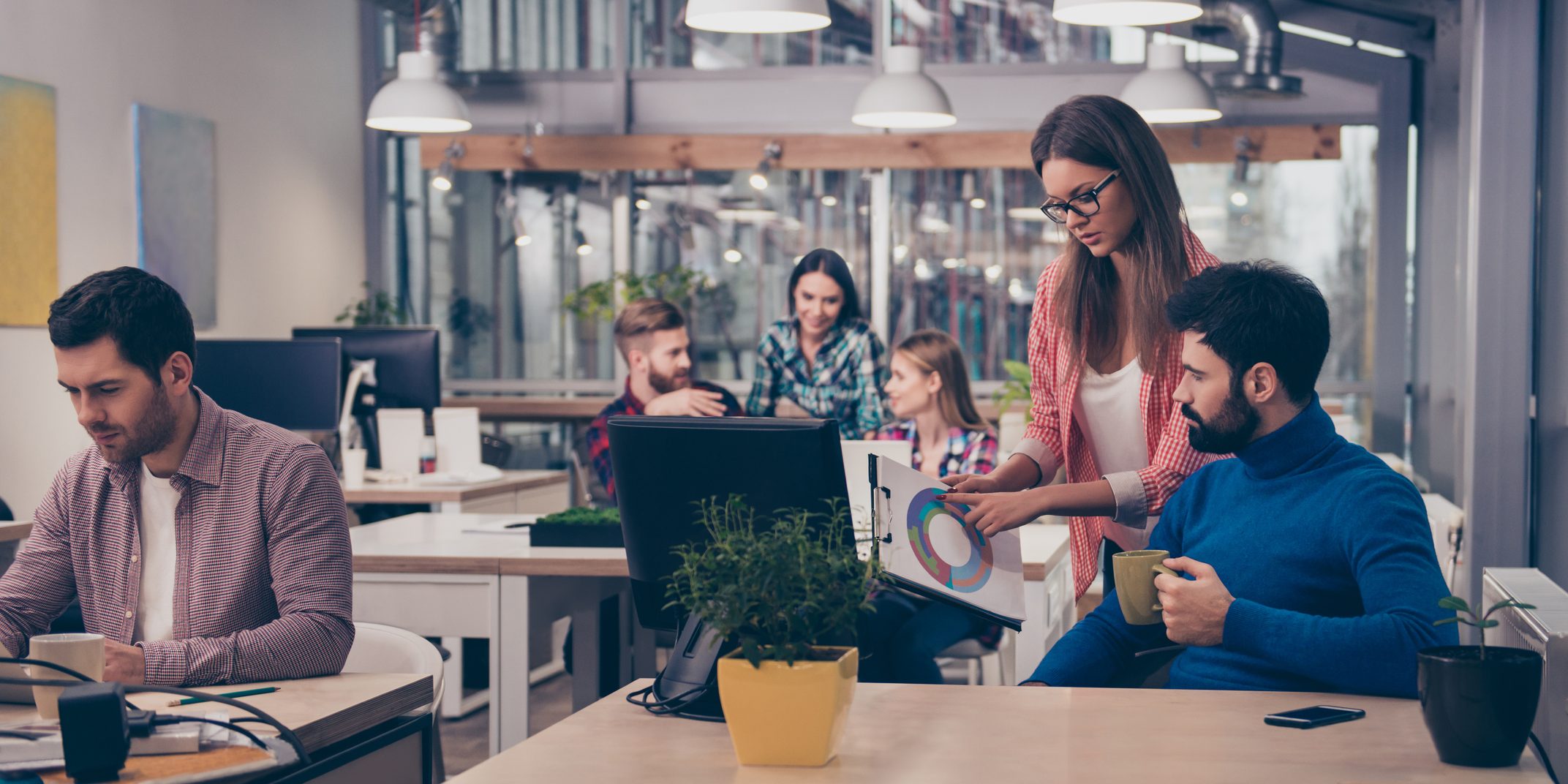 Young woman showing diagrama of growth to her colleague